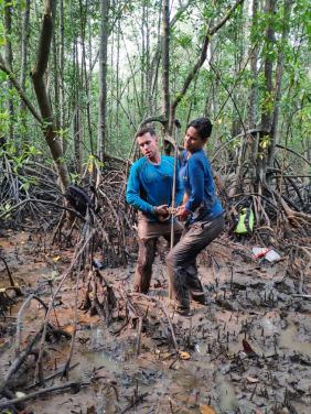 Image 1. Dr Nicole Khan (right) and her colleague investigating the growth of mangroves. (Photo courtesy:Nicole Khan)