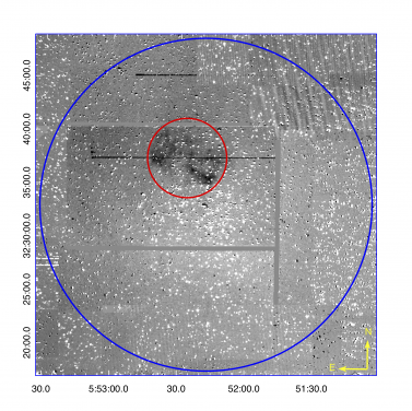 Figure 1. A contrast enhanced 30°ø30 arcminute quotient (Hα−r band) IPHAS (Drew et al. 2005) mosaic centred on the core of Galactic open cluster M 37 (NGC 2099). The low surface brightness bipolar PN (IPHASX J055226.2+323724) is encompassed by a red circle with a diameter of 445 x 10 arcseconds (the nebular major axis) while the blue circle indicates the full ∼ 30 arcminute extent of the cluster. The PN is well within the cluster tidal radius with the blue CSPN at almost the precise geometric centre of the PN. The CSPN is itself only ∼280 arcseconds from the published cluster center position.