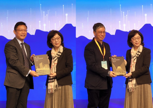 Professor Wei Pan and Ir K.L. Tam receive the Outstanding People (MiC Advocator) from Ms Bernadette Linn, Secretary for Development, HKSAR